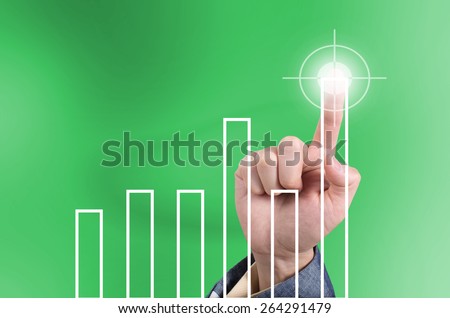 Hit the target, business concept with finger touching top bar chart on a virtual touch screen