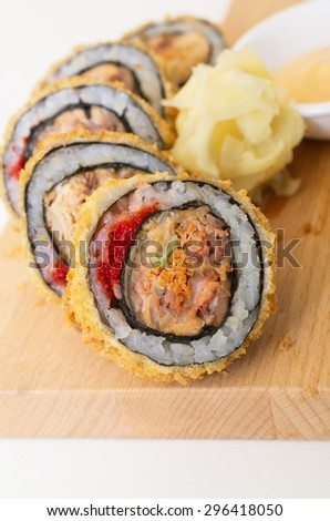 Dragon Eyes roll on a wooden plate against white background