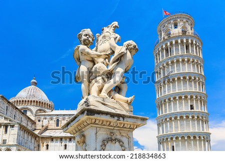 The statue of angels and the leaning tower. Square of Miracles in Pisa, Italy