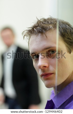 Pane,young, white man\'s face portrait, another man in background
