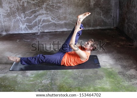 fusion of mind and body - caucasian man on mat practicing pilates