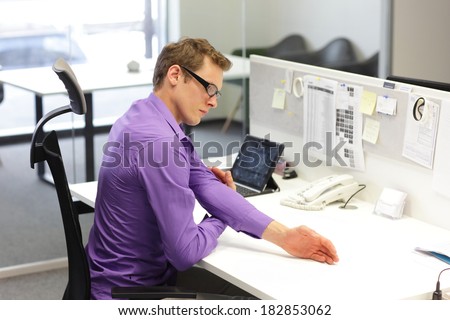 man  office worker,exercising during work with tablet in his office