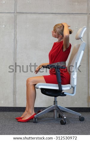 yoga on chair in office - business woman exercising