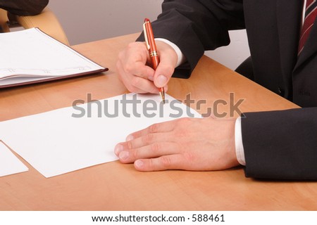 business man signing blank paper on the desk