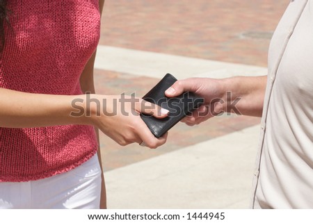 man giving a wallet to the woman - close up