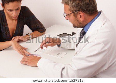 at the doctor's office - doctor explainig diagnosis to his female patient