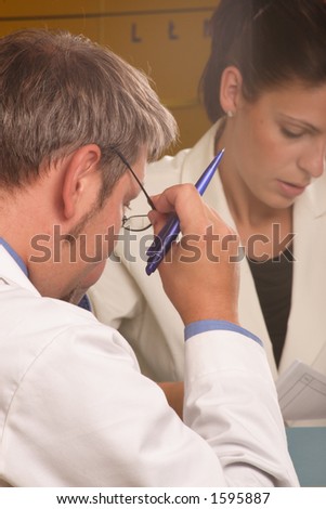 Medical secretary and doctor working together in the office