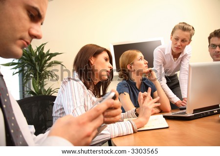 Group of five business people working together on project - three men and two women