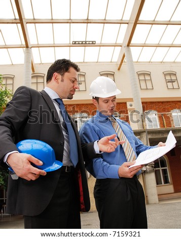 architect talking to investor over the blueprints