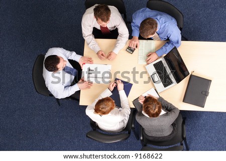 leadership - mentoring, five business people meeting - Businesspeople gathered around a table for a meeting, brainstorming. Aerial shot taken from directly above the table.