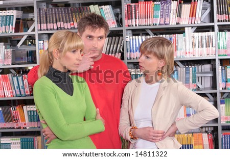 two women and one man working in the library