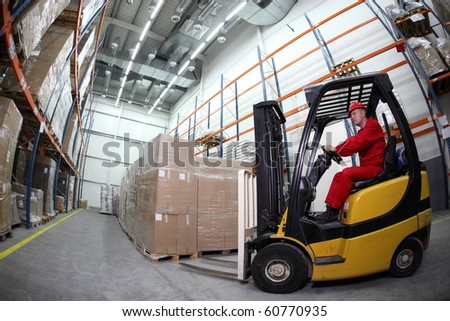 forklift  truck reloading pallets in storehouse