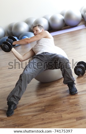 Fitness program, weight lifting on stability ball