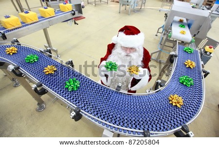 santa claus as a quality control manager at christmas ornament production line in factory
