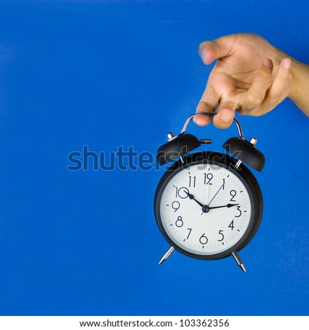 Man hands the old-fashioned alarm clock isolated on a color background