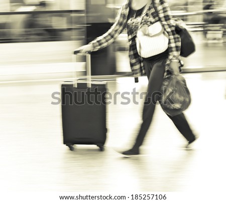 Pushing luggage ready to ride the plane at the airport, black and white blurred images