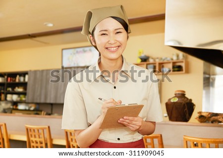 Japanese restaurant clerk taking an order