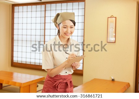Japanese restaurant clerk taking an order