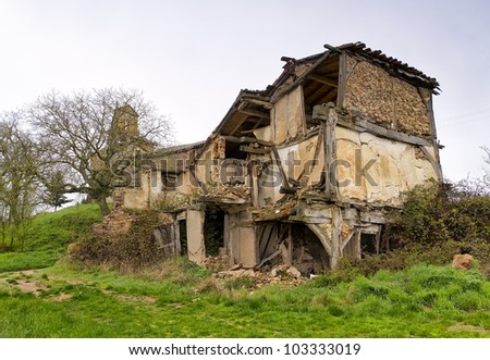 Homes and church in ruins of an abandoned village in the province of Burgos, Spain.