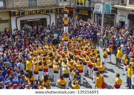 BARCELONA, SPAIN - MAY 19: Some unidentified people called Castellers do a Castell or Human Tower, typical tradition in Catalonia, on May 19, 2013 in Barcelona, Spain.