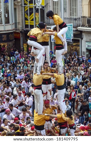 BARCELONA, SPAIN - MAY 19: unidentified people called Castellers do a Castell or Human Tower, typical tradition in Catalonia, on May 19, 2013 in Barcelona, Spain.