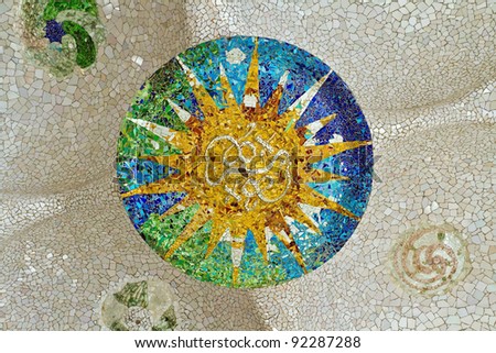 Ceiling with mosaic sun at Guell Park, Barcelona, Spain.