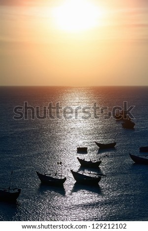 decline the sun, the sea with silhouettes of fishing boats.