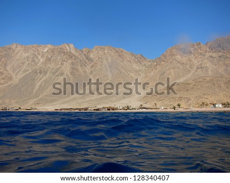 blue sea with high mountain in desert in egypt