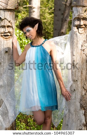 Elf girl between two trees with colorful dress /Elf