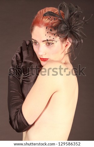 Portrait of a model with an elaborate hairstyle with ribbon in her hair and black gloves / Hair variant