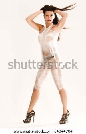 Young nude woman wrapped in foil packaging / packaged wife