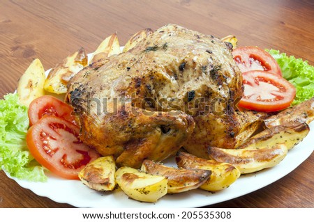 Whole roasted chicken on plate with vegetables