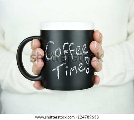 woman holding mug of coffee with coffee time text in chalk