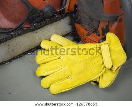 leather work gloves with chainsaw and helmet