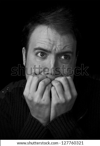 fear, man scared biting fingernails black and white portrait