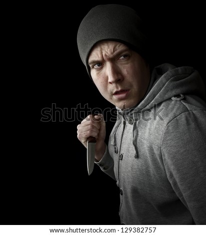 violent crime, man with knife on black background with copy space