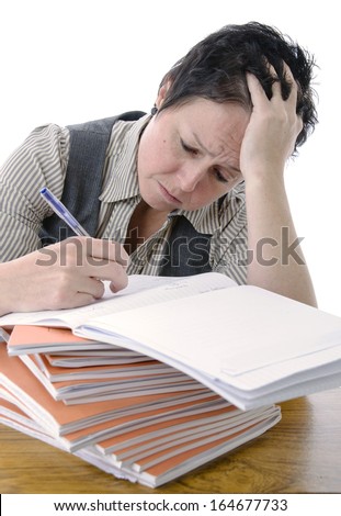 bored / frustrated teacher marking students work on desk