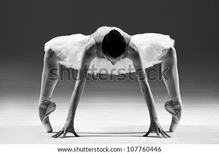 beautiful classic Ballet Dancer in white Tutu standing in complicate position