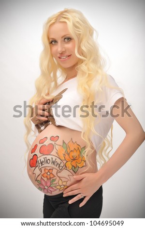portrait of a beautiful blonde with a pregnant belly painted