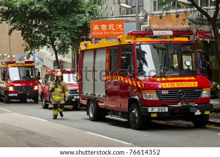 HONG KONG - MAY 02: Firemen and fire trucks arrive in morning on May 02, 2011 in Chai Wan, Hong Kong, China. A 19-year-old woman died and three people were injured in the fire.
