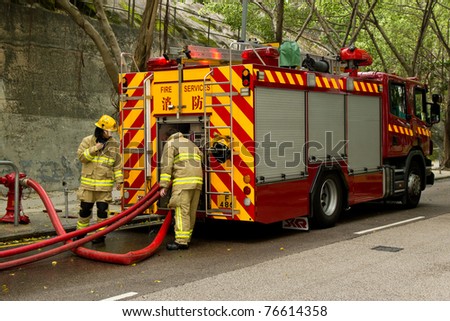 HONG KONG - MAY 02: Firemen and fire trucks arrive in morning on May 02, 2011 in Chai Wan, Hong Kong, China. A 19-year-old woman died and three people were injured in the fire.