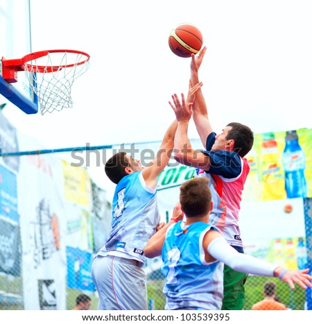 BUCHAREST, ROMANIA - MAY 20: Unknown basketball  players performs during the game Sport Arena Streetball 3x3, Play On (red) vs. Tiki Taka Polit (blue) on May 20, 2012 in Bucharest, Romania