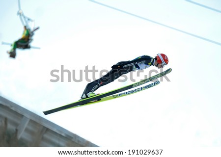 Rasnov, Romania - March 1: Unknown ski jumper competes in the FIS Ski Jumping World Cup Ladies on March 1, 2014 in Rasnov, Romania