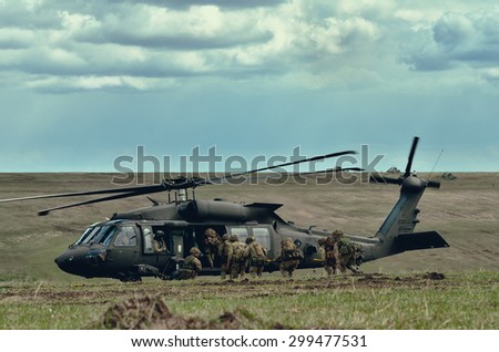 GALATI, ROMANIA - 09 APRIL: UK special forces elite demonstrating evacuation skills during combat using a UH-60 Black Hawk helicopter at the military poligon in April 09, 2015 near Galati, Romania