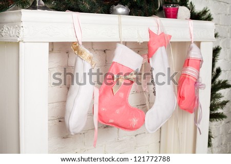 Christmas socks with gifts on the fireplace
