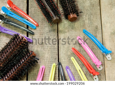 Hair brush comb and Hairpins on wooden background