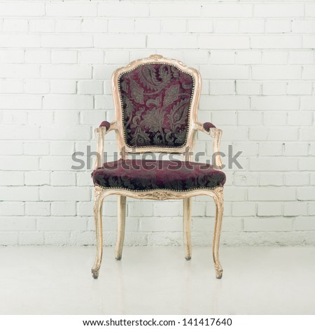 Wooden vintage chair against a brick wall
