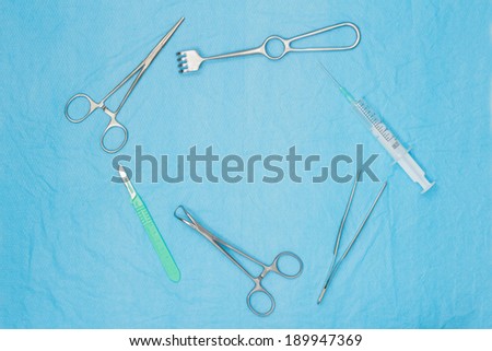 Surgical tools on a medical non-woven fabric cloth. Surgical background with copy space