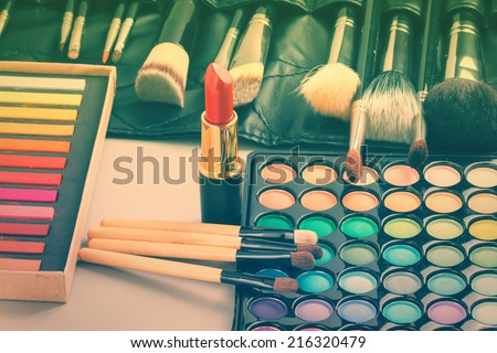 Makeup cosmetics collection - lipstick, palette, professional makeup brushes etc. Toned image