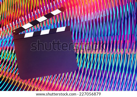 Movie clapper board against light painting background. Entertainment concept